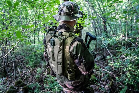 Special forces mercenary soldiers dogs of war in the forest during the combat battle operation on the missionの写真素材