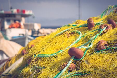 Yellow fishing net on the dock in harbor by the sea in summer dayの写真素材
