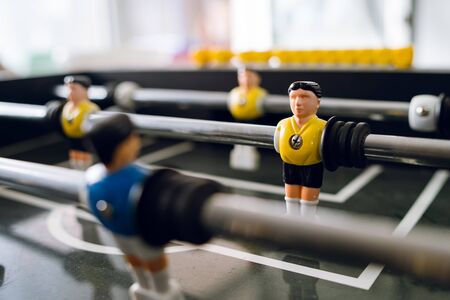 Close up on players of Table football soccer kicker foosball top-table game