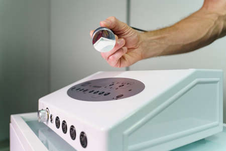 Ultrasonic ultrasound medical equipment unknown man hand holding device for massage and pain relief therapyの写真素材