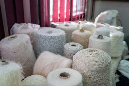 Close up on wool thread rolls on the table at traditional craft workshop