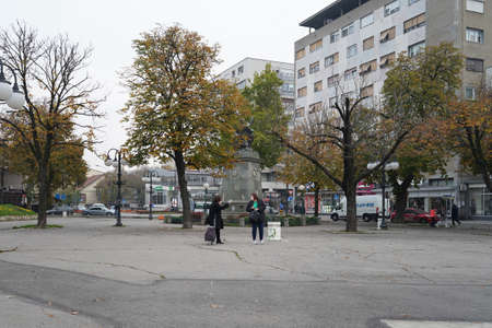 Zajecar, Serbia - 18. 11. 2020: City square with monument in autumn day in ZajeÄar, pedestrians...