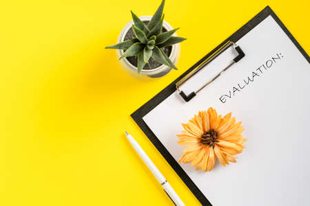 Mock up office accessories on yellow background flat lay of business gadgets evaluation concept