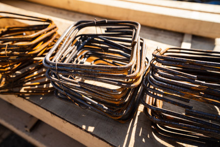 Close up on the construction armature iron frames on the other building material at the construction site in sunny dayの写真素材