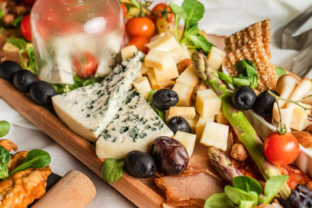 Close up on appetizer food on the table black olives and cheeseの写真素材