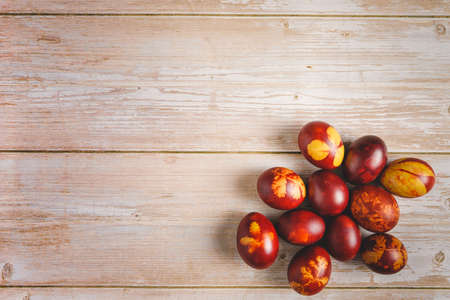 Top down flat lay view on easter eggs painted on wooden background with copy spaceの写真素材