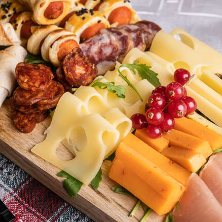 Close up on appetizer food on the table cheese and sausageの写真素材