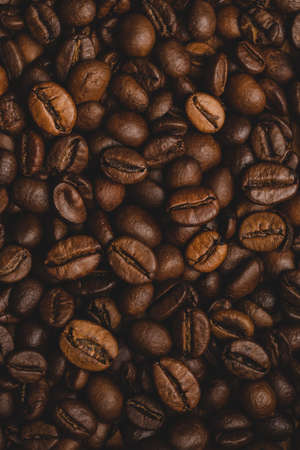 Coffee beans roasted full frame background Close up macro dark brown