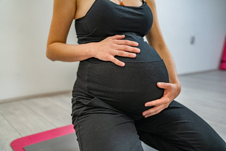 One woman pregnant female practice stretching at studio or home yoga and fitness pregnancy concept...