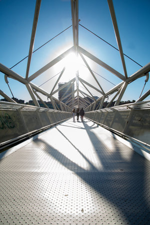 valladolid, spain July 5, 2020: people walking through the iron bridge summer day. valladolid, spainのeditorial素材