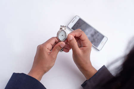 Young girl setting time on silver watch, close up photo, high quality photography, white background,...
