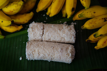 Popular Steamed Kerala Breakfast Dish served in banana leaf with yellow banana, puttu and yellow small banana served in banana leaf top viewの写真素材