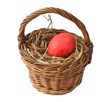 Red Easter egg in basket on a white backgroundの写真素材