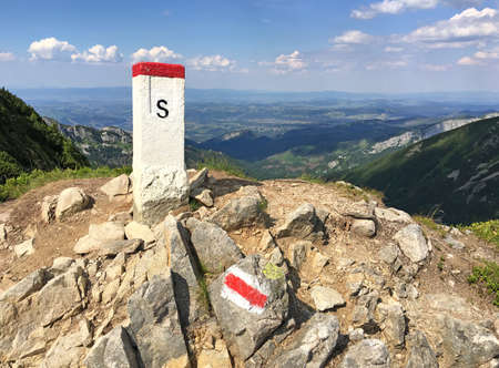 The border post is high in the mountains. Border of Poland and Slovakia in the Tatra Mountains. Tourist route.の写真素材