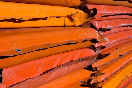A lot of orange mattresses stacked in a rowの写真素材