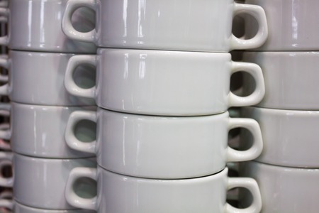 Pure white dishes is neatly standing in the cafeの写真素材