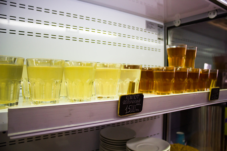Many glasses of fruit juice on the counterの写真素材