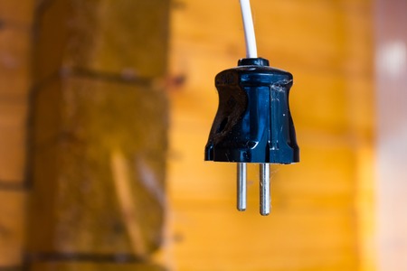 Plug with white wire hanging at a construction site view from belowの写真素材