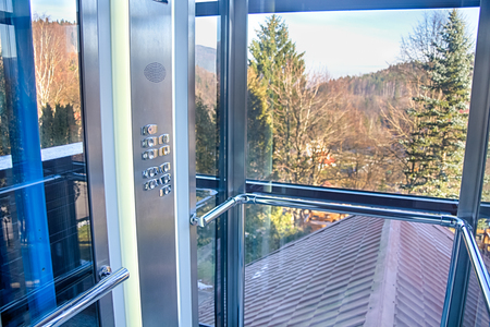 Trendy elevator with transparent walls rises to you