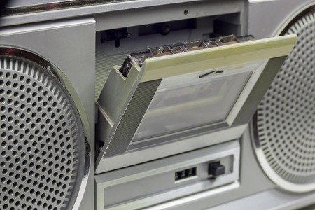 Old and  retro audio cassete player with the open deck and cassette insideの写真素材
