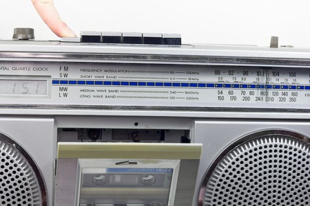 Old and  retro audio cassete player with the open deck and cassette inside