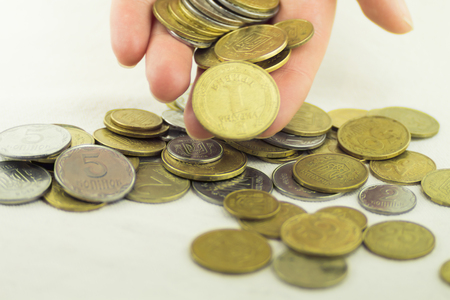 Lots of coins of different values on a white backgroundの写真素材