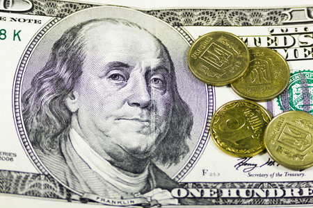 Coins and one hundred dollars banknote backgroundの写真素材