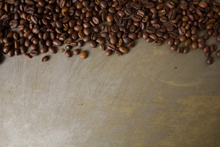 A lot of black coffee beans background on the original steel backgroundの写真素材