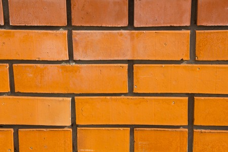 Wall of new red brick as a background and texture