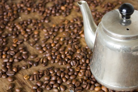 Vintage teapot coffee beans on a wooden tableの写真素材