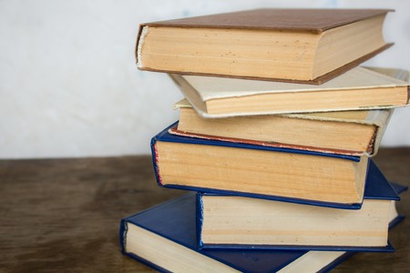 A stack of old big books on the white background