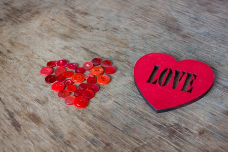 Heart of red buttons and love  inscriptionの写真素材