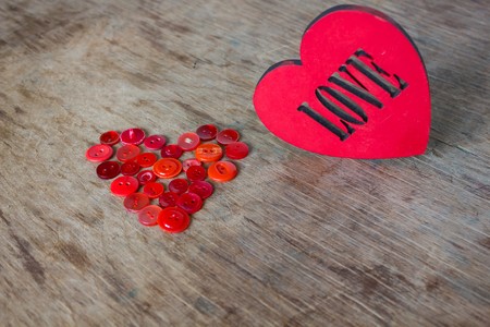 Heart of red buttons and love  inscription