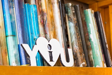 many different books on a bookshelf in the library and the inscription on the white stencil I love...