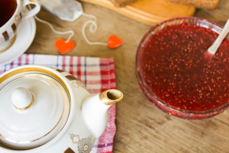 light breakfast or lunch , Raspberry jam slices of black bread Vintage cup of tea and teapotの写真素材