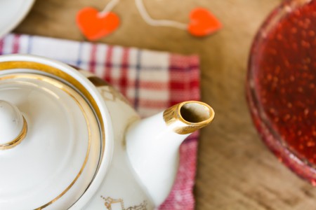 light breakfast or lunch , Raspberry jam slices of black bread Vintage cup of tea and teapot