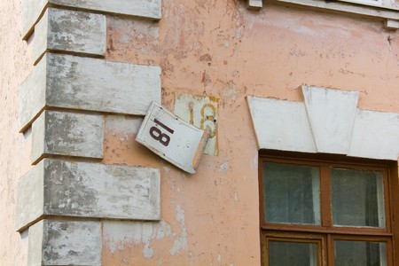 Rickety old sign with the house number 18の写真素材