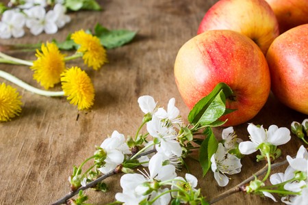 Wooden old scratched the surface of apples and flowersの写真素材