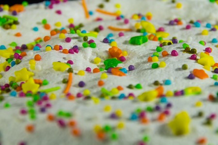 Small multi-colored Easter powder on the cake close up view