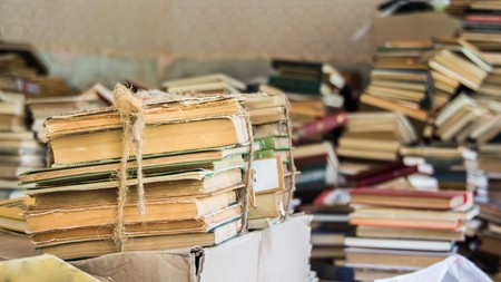 Books are scattered in the sloppy pile close up viewの写真素材