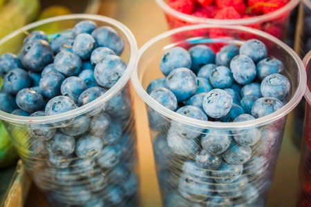 fresh blueberries, currants, blackberries, cranberries and raspberries. Focus berries in spoonの写真素材