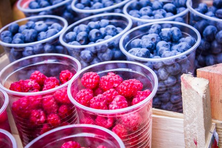 fresh blueberries, currants, blackberries, cranberries and raspberries. Focus berries in spoonの写真素材