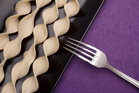 pasta pappardelle curly and fork background purple, violetの写真素材