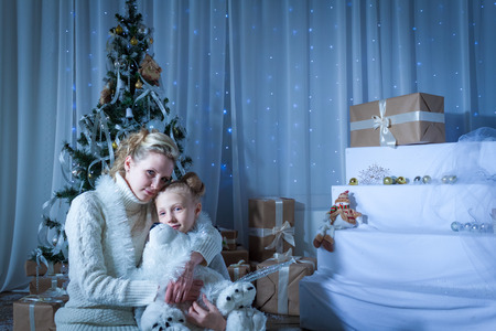 Beautiful woman and her daughter near the New Year treeの写真素材