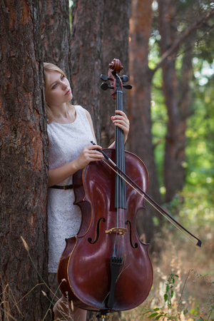Musician with cello outdoorsの写真素材