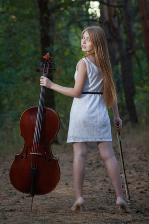 Professional musician with cello outdoorsの写真素材