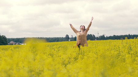Happy young woman on a summer walk. Woman walking in summer field