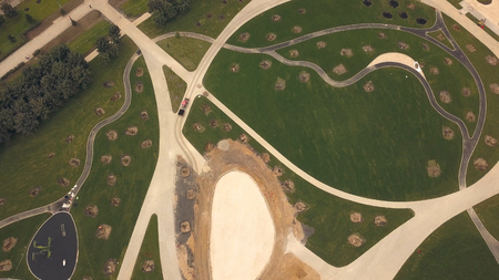 Aerial view construction people park in new neighborhood young city. Construction site square in modern city. Construction area green park in city neighborhood. Paths and lawns in new nature parkの写真素材
