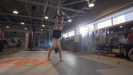 Strong man walking on hand during crossfit training in fitness clubの写真素材