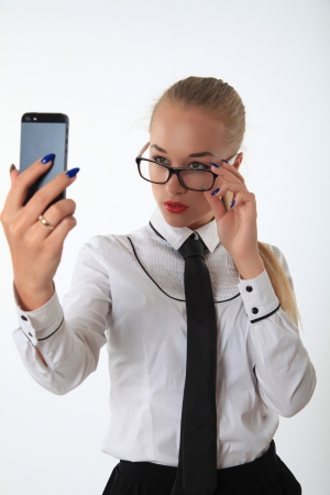 Business woman looks at the mobile phoneの写真素材